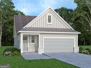 view of front facade with board and batten siding, concrete driveway, an attached garage, and a front yard