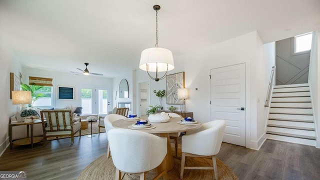 dining area featuring wood finished floors, stairway, ceiling fan, and baseboards