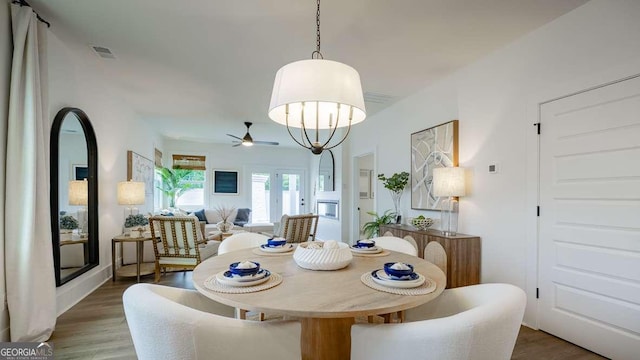 dining area featuring wood finished floors and a ceiling fan