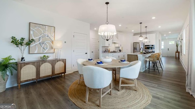 dining space with recessed lighting, dark wood-style floors, baseboards, and a chandelier