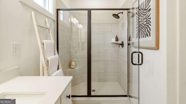 bathroom featuring a shower stall and vanity