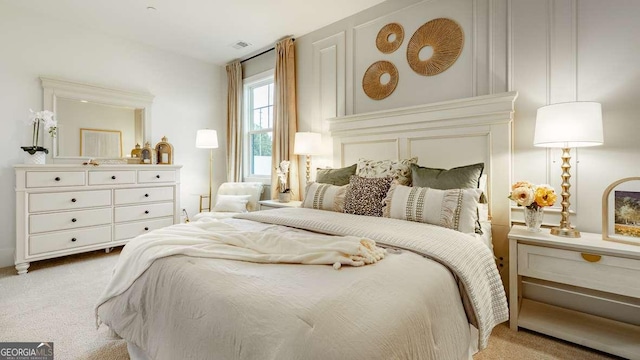 bedroom with carpet and a decorative wall