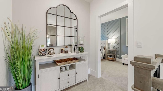 corridor with light colored carpet and baseboards