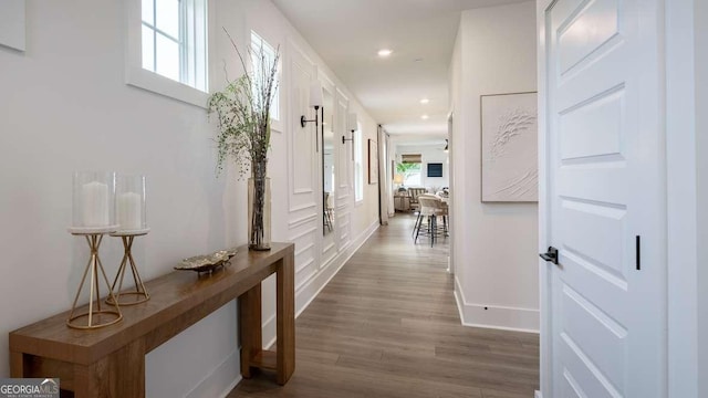 hallway featuring dark wood finished floors, recessed lighting, and baseboards