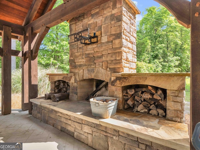 view of patio with an outdoor stone fireplace
