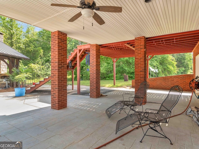 view of patio / terrace with stairs and ceiling fan