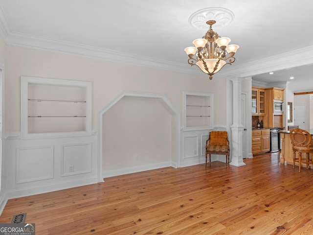 unfurnished dining area with built in features, a chandelier, light wood-type flooring, ornamental molding, and recessed lighting
