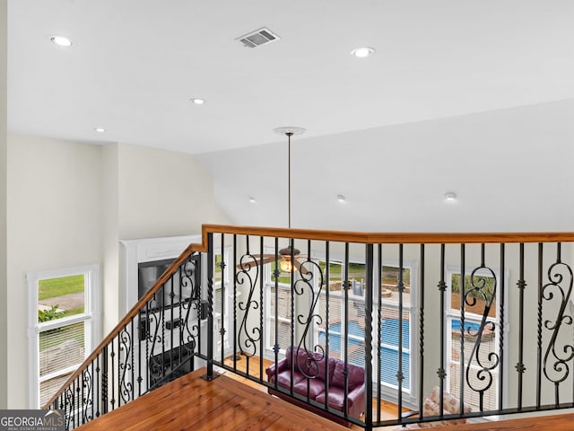 hall with wood finished floors, recessed lighting, and high vaulted ceiling