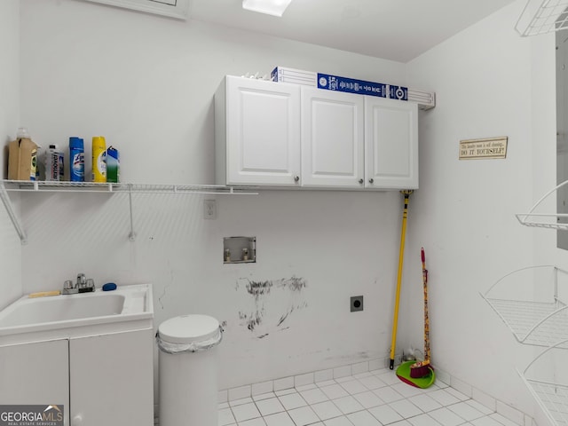 washroom with washer hookup, cabinet space, electric dryer hookup, and tile patterned floors