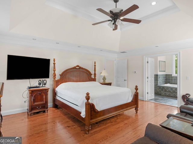 bedroom featuring crown molding, light wood-style flooring, recessed lighting, baseboards, and connected bathroom