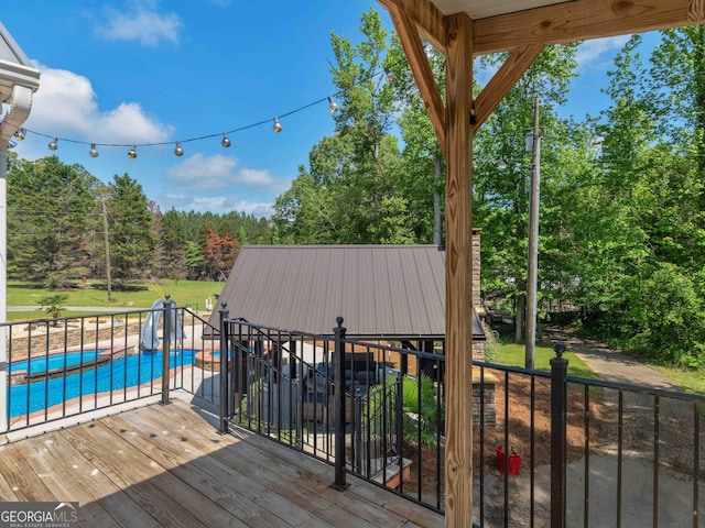 wooden deck featuring view of wooded area and a yard