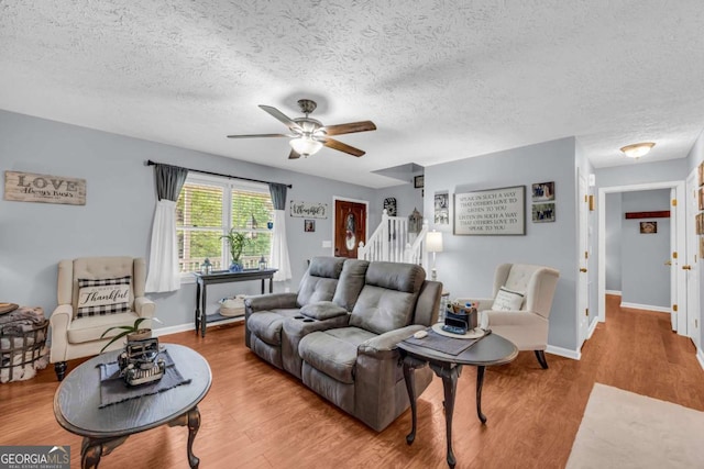 188 Mayapple Gln, Dawsonville, GA 30534 - living area featuring a ceiling fan, a textured ceiling, wood finished floors, and baseboards