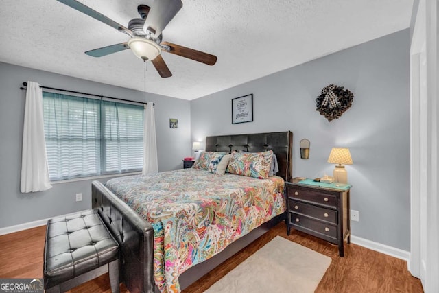 188 Mayapple Gln, Dawsonville, GA 30534 - bedroom with a textured ceiling, wood finished floors, baseboards, and ceiling fan