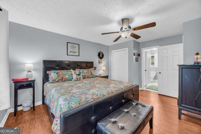 188 Mayapple Gln, Dawsonville, GA 30534 - bedroom featuring wood finished floors, a textured ceiling, a closet, baseboards, and a ceiling fan