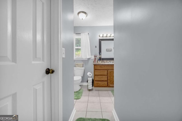 188 Mayapple Gln, Dawsonville, GA 30534 - bathroom with toilet, tile patterned flooring, vanity, a textured ceiling, and baseboards