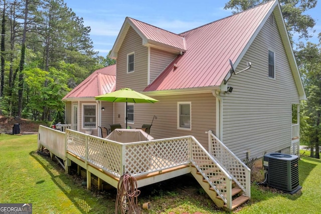 188 Mayapple Gln, Dawsonville, GA 30534 - rear view of property featuring central air condition unit, metal roof, a yard, and a deck