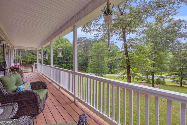 188 Mayapple Gln, Dawsonville, GA 30534 - wooden porch featuring a lawn