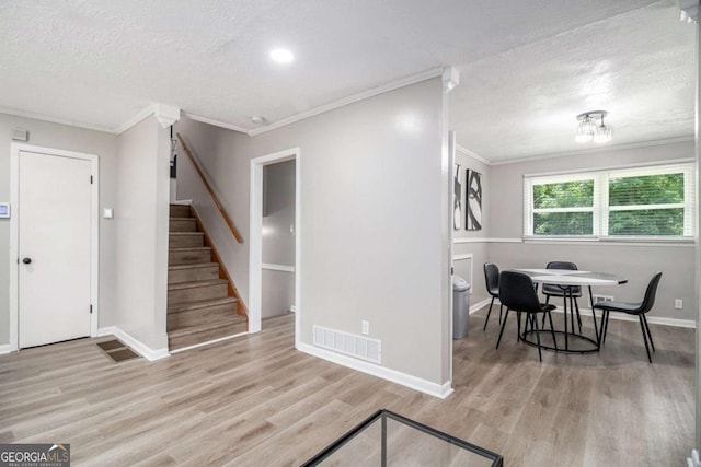479 Charter Oak Dr SW, Atlanta, GA 30331 - dining space featuring crown molding, wood finished floors, a textured ceiling, and stairway