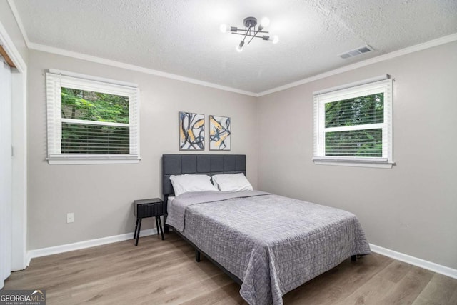 479 Charter Oak Dr SW, Atlanta, GA 30331 - bedroom featuring a textured ceiling, multiple windows, wood finished floors, and crown molding