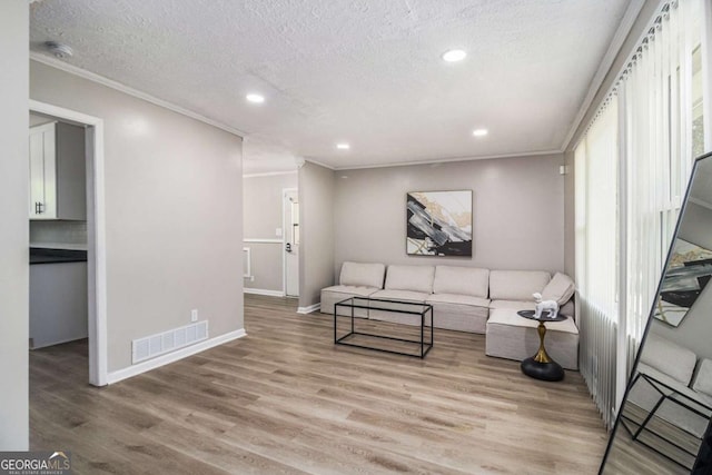 479 Charter Oak Dr SW, Atlanta, GA 30331 - living room featuring crown molding, light wood-style floors, a textured ceiling, and recessed lighting