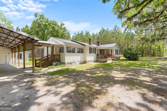 2445 Wilma Edwards Rd, Ellabell, GA 31308 - view of front facade with a carport, crawl space, a chimney, and covered porch