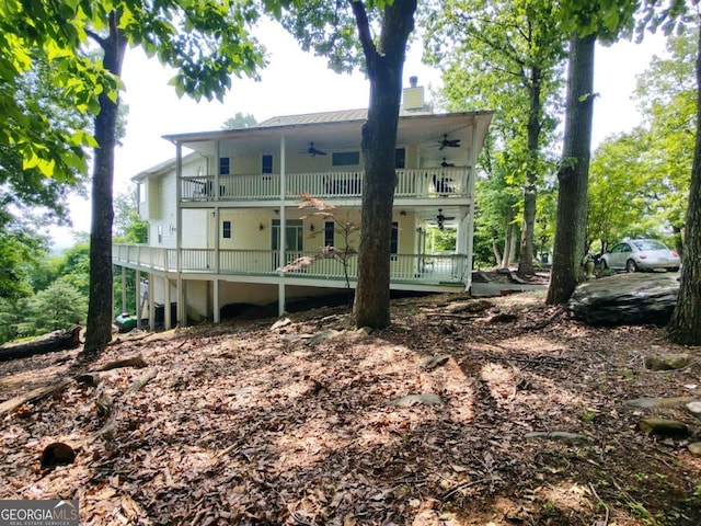 rear view of house with a ceiling fan, a balcony, and covered porch