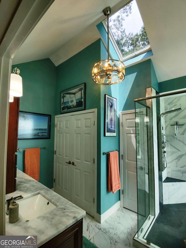 bathroom featuring vaulted ceiling, marble finish flooring, a marble finish shower, a skylight, and a chandelier