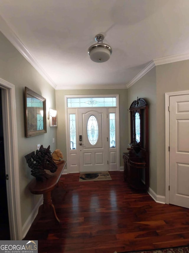 foyer entrance with wood finished floors, crown molding, and baseboards