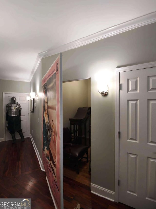 hallway with crown molding, wood finished floors, and baseboards