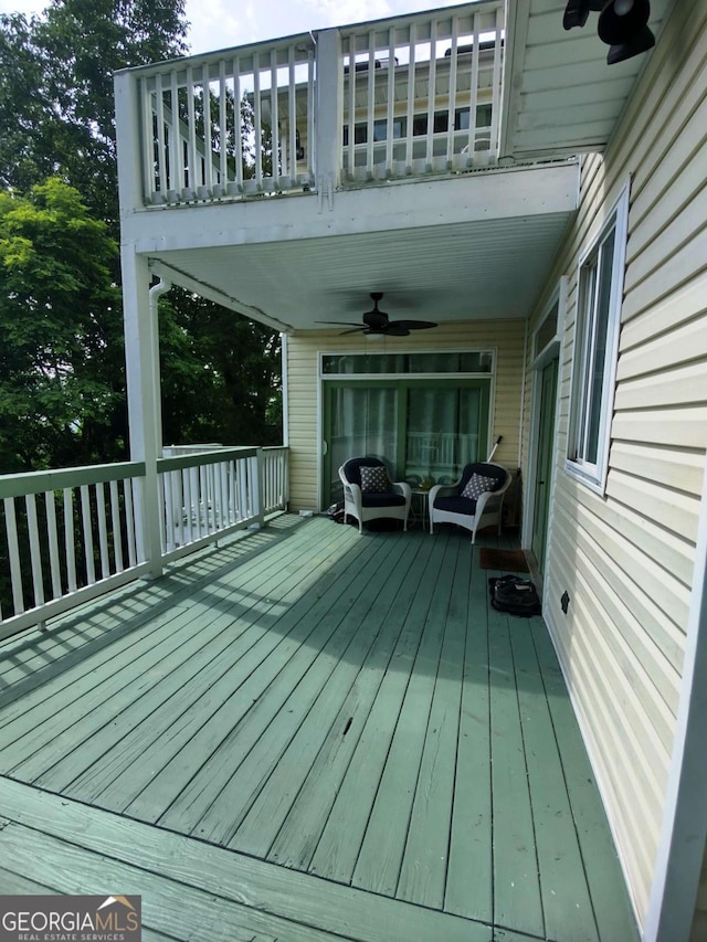 deck featuring ceiling fan and outdoor lounge area