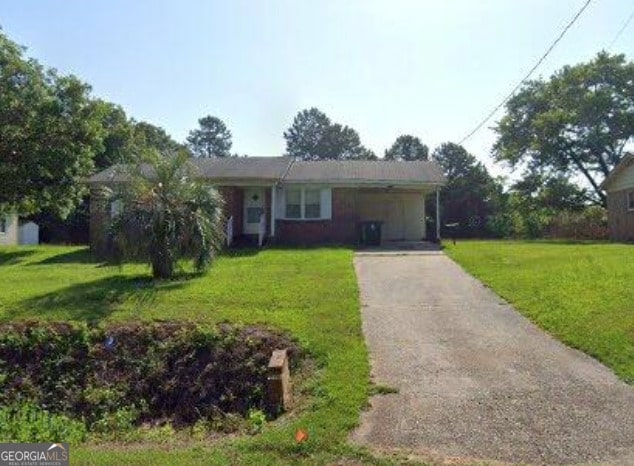 ranch-style house with asphalt driveway, a front lawn, and a carport