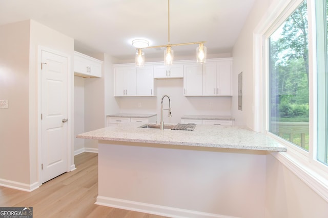 330 Stonehenge Way, Athens, GA 30606 - kitchen featuring a sink, white cabinets, light wood-style flooring, and light stone counters