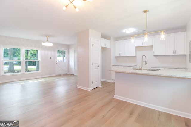 330 Stonehenge Way, Athens, GA 30606 - kitchen with a sink, white cabinets, light wood-style flooring, baseboards, and light stone counters