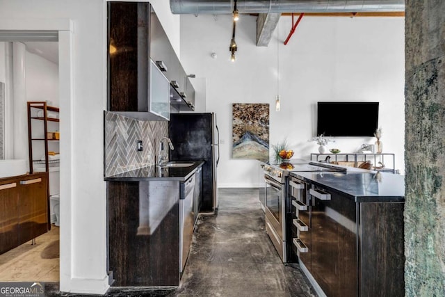 650 Glen Iris Dr NE Unit 27, Atlanta, GA 30308 - kitchen featuring appliances with stainless steel finishes, a towering ceiling, decorative backsplash, dark brown cabinets, and finished concrete floors