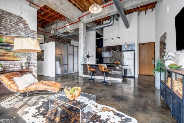 650 Glen Iris Dr NE Unit 27, Atlanta, GA 30308 - living area with a high ceiling, concrete flooring, and brick wall