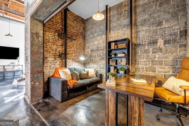 650 Glen Iris Dr NE Unit 27, Atlanta, GA 30308 - living area with concrete flooring and brick wall