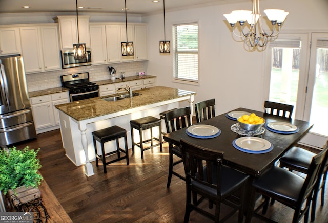 878 W Union Grove Cir, Auburn, GA 30011 - dining space with ornamental molding, dark wood finished floors, a chandelier, and recessed lighting