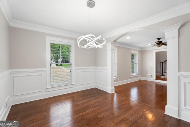 unfurnished dining area with decorative columns, wood finished floors, ceiling fan, wainscoting, and arched walkways