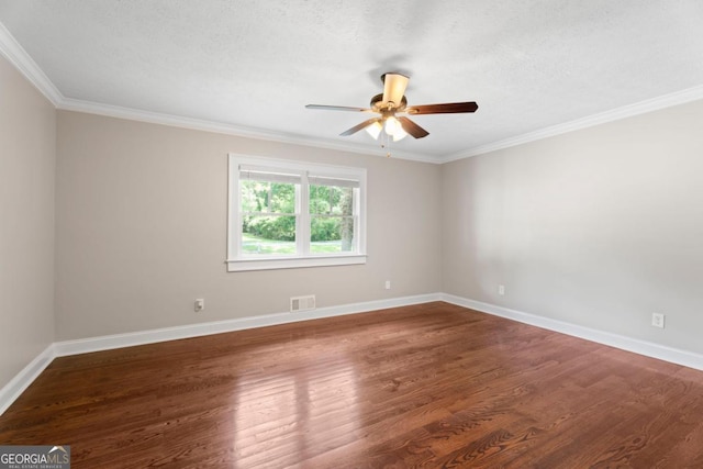 spare room with ceiling fan, wood finished floors, baseboards, and crown molding