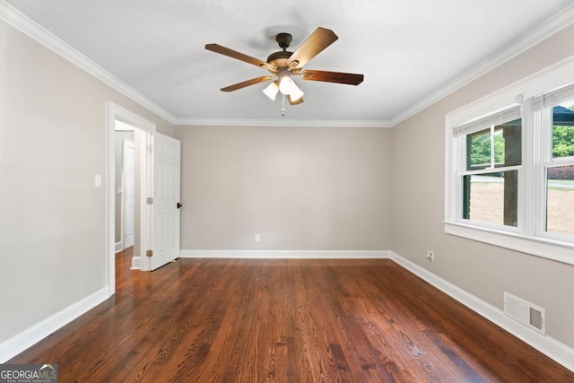 spare room featuring a ceiling fan, ornamental molding, dark wood-style floors, and baseboards