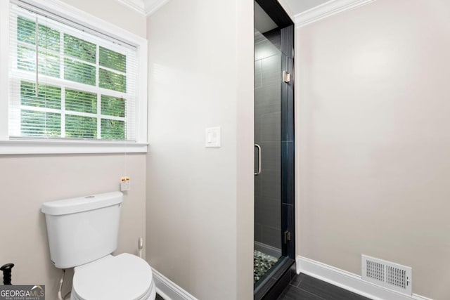 full bathroom with baseboards, ornamental molding, a stall shower, and toilet