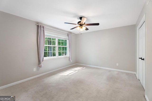 unfurnished bedroom with light carpet, baseboards, a closet, and ceiling fan
