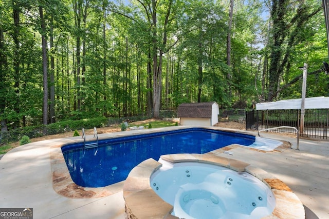 view of swimming pool with a pool with connected hot tub and a patio area