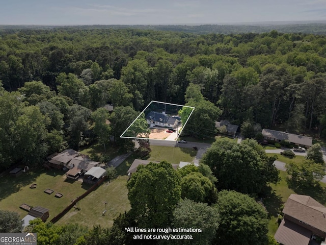 aerial view of property's location with a heavily wooded area and property parcel outlined