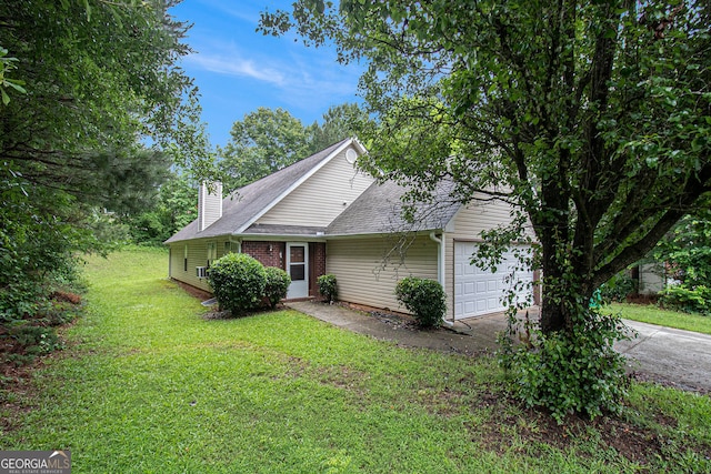 4732 Browns Mill Ferry Rd, Lithonia, GA 30038 - view of property exterior with an attached garage, asphalt driveway, a yard, a chimney, and brick siding