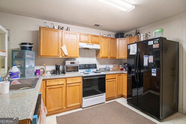 4732 Browns Mill Ferry Rd, Lithonia, GA 30038 - kitchen with black fridge, white range with electric cooktop, under cabinet range hood, a sink, and light countertops