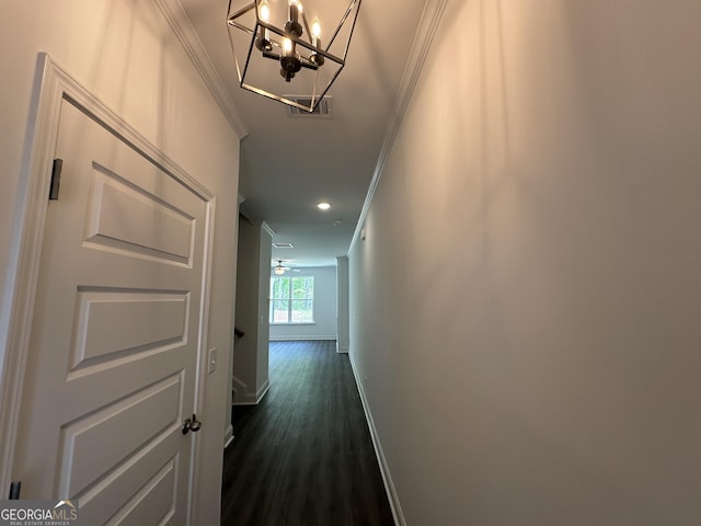 hallway featuring ornamental molding, a chandelier, baseboards, dark wood-style floors, and recessed lighting
