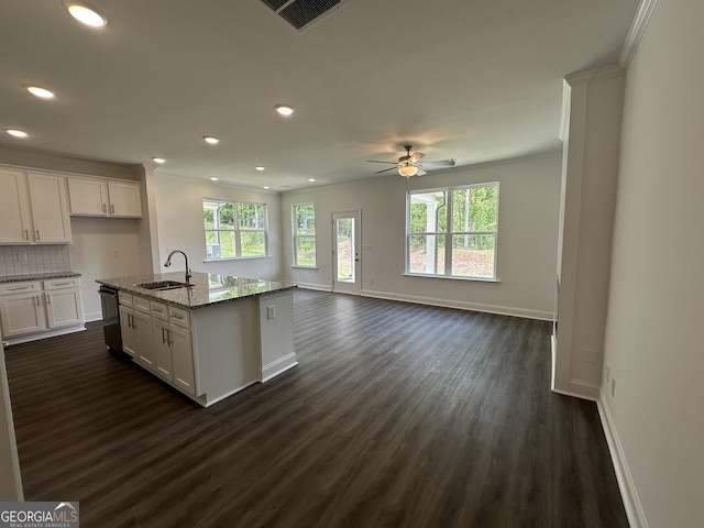 kitchen featuring a sink, a ceiling fan, dark wood-type flooring, stone countertops, and recessed lighting