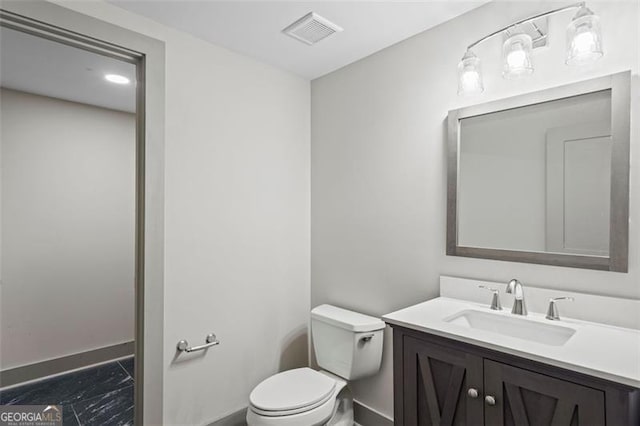 664 Florence Pl NW, Atlanta, GA 30318 - half bath with baseboards, marble look tiles, toilet, and vanity