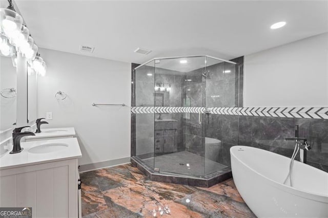 664 Florence Pl NW, Atlanta, GA 30318 - full bath featuring marble tiled floors, a soaking tub, a shower stall, double vanity, and recessed lighting